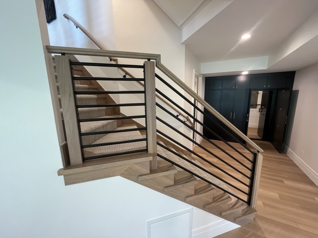 Custom stair rail, light wood and steel balusters